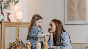 A loving mother and daughter enjoying quality time together in a cozy kitchen setting.